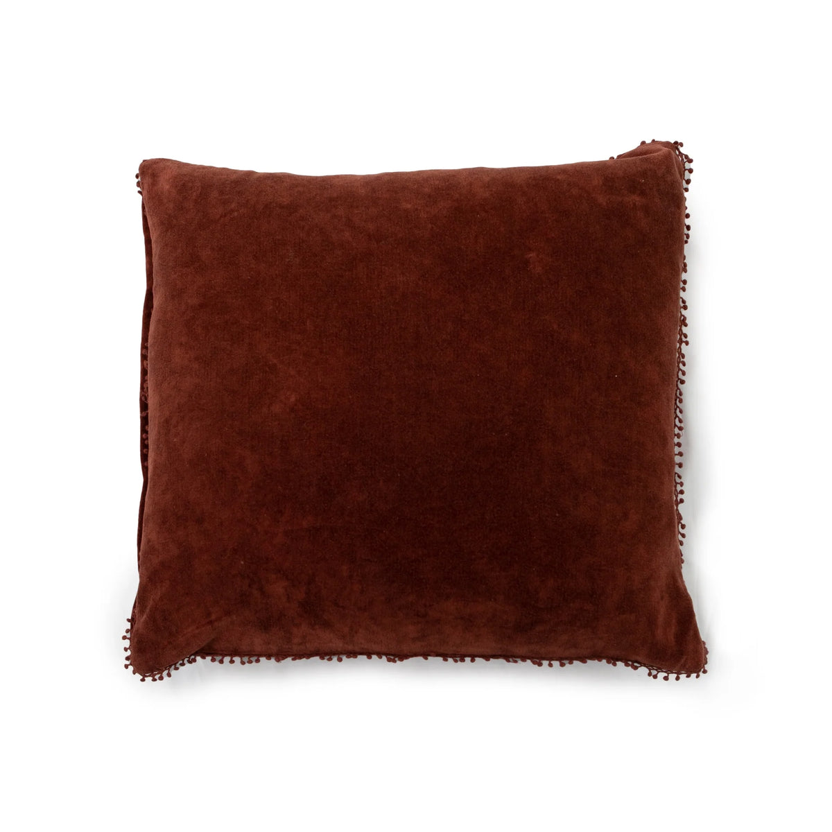 Velvet rust pillow with pom trim by Sugarboo Designs, decorative accent for living room or bedroom.