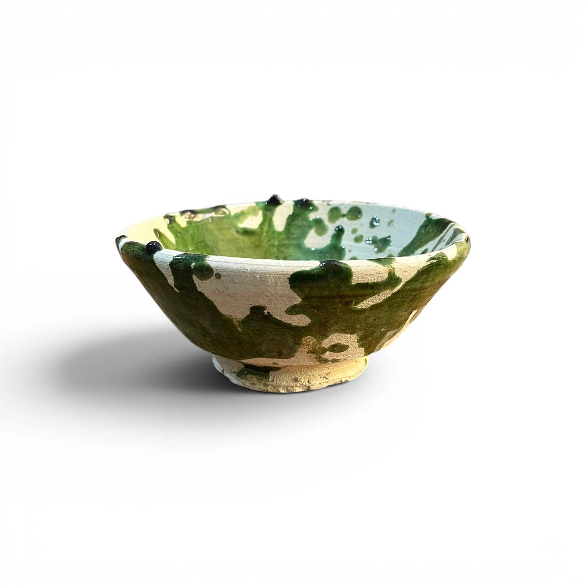 Green Moroccan-inspired ceramic bowl by Bungalow Furniture &amp; Accessories with splatter design on white background.
