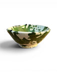 Green Moroccan-inspired ceramic bowl by Bungalow Furniture & Accessories with splatter design on white background.