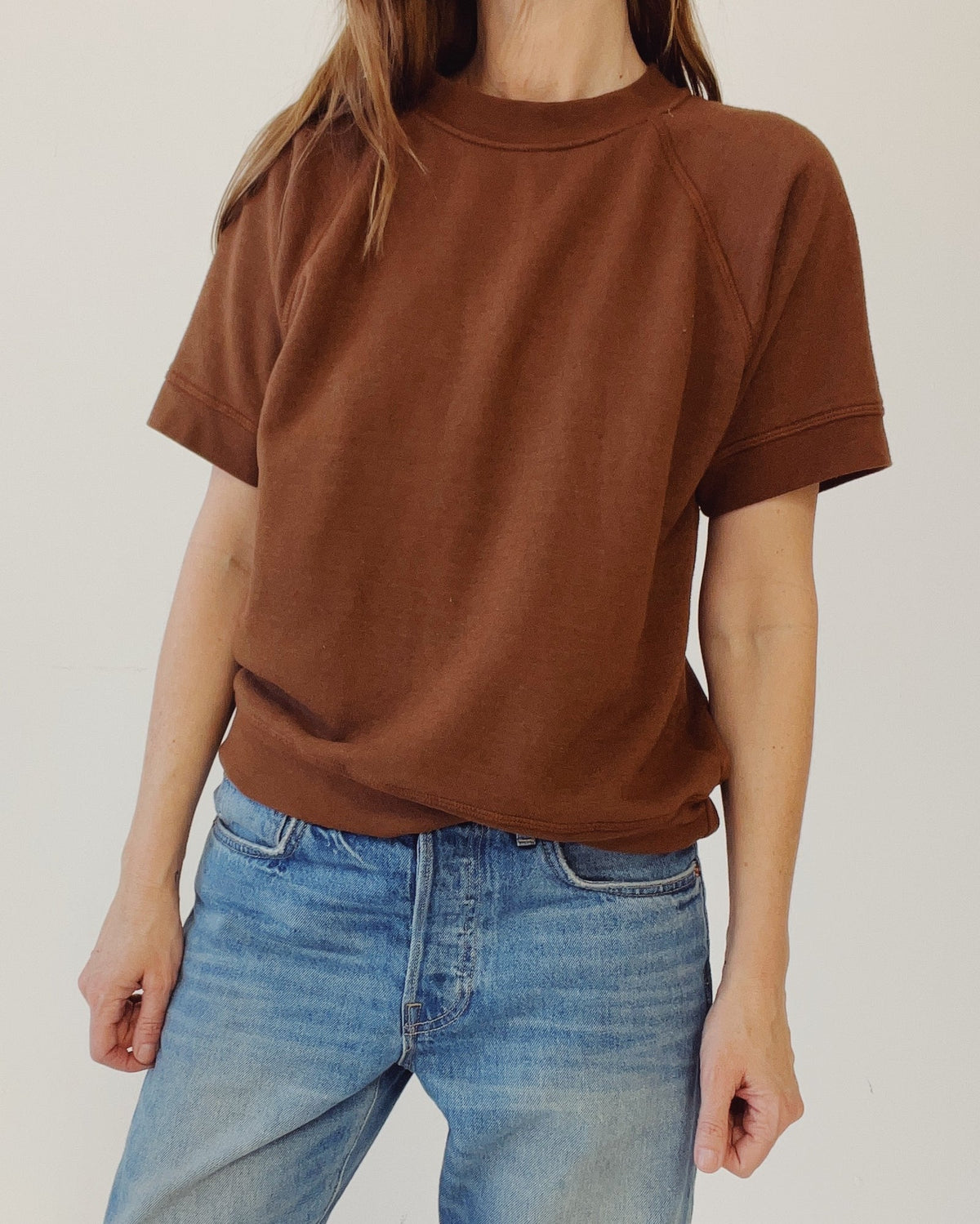 Cedar S/S Sweatshirt by Hey Gang in light color, paired with blue jeans, shown in a minimal studio setting.