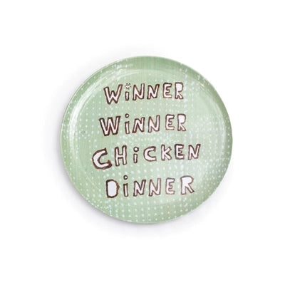 The Breakfast Club Plate Set by Sugarboo Designs features a green plate with a dotted pattern and "Breakfast Of Champions Winner Winner Chicken Dinner" in brown, playful letters at the center.