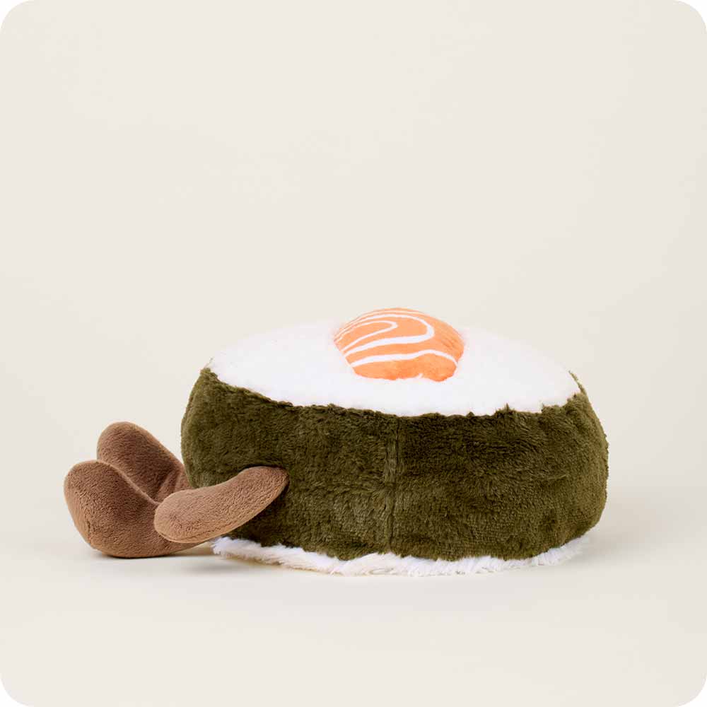 The Salmon Sushi Warmies by Faire is a microwavable plush toy shaped like a sushi roll with a white and green body, orange salmon top, and brown fin flaps, designed to offer sensory comfort.