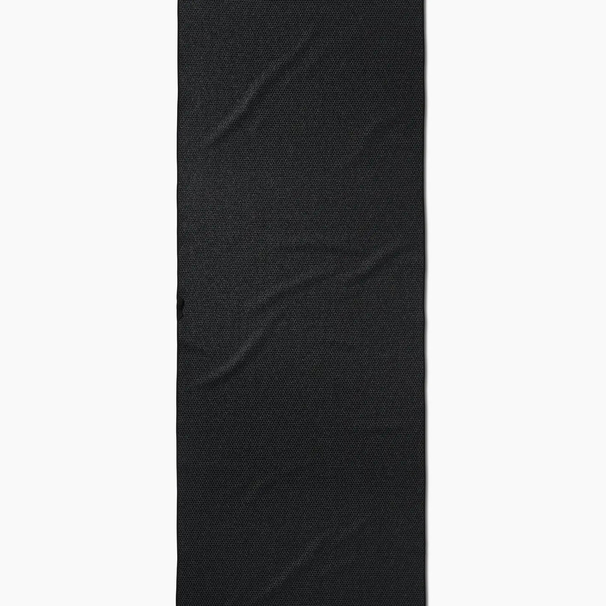 The Faire Leopard Yoga Towel, an ultra-absorbent black towel with a subtle textured pattern and visible wrinkles, is shown vertically against a white background.
