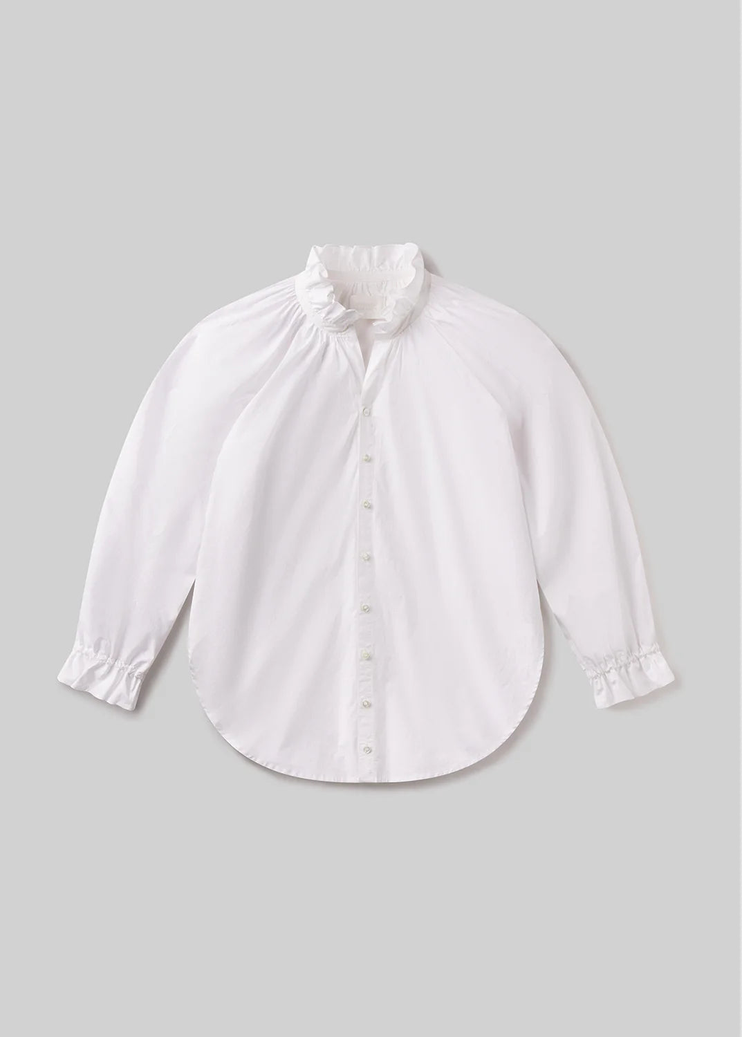 The loretta ruffle top in optic white by Citizens Of Humanity/AGOLDE, featuring a high ruffled collar, button-down front, and ruffled cuffs, is shown on a plain light gray background.