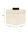 The Import Collection’s 46-056 Foley Box is a square, cream-colored storage box with a black lid, measuring 6"W x 6"D x 5.5"H. Featuring measurement lines and labels, it's perfect for modern home decor.
