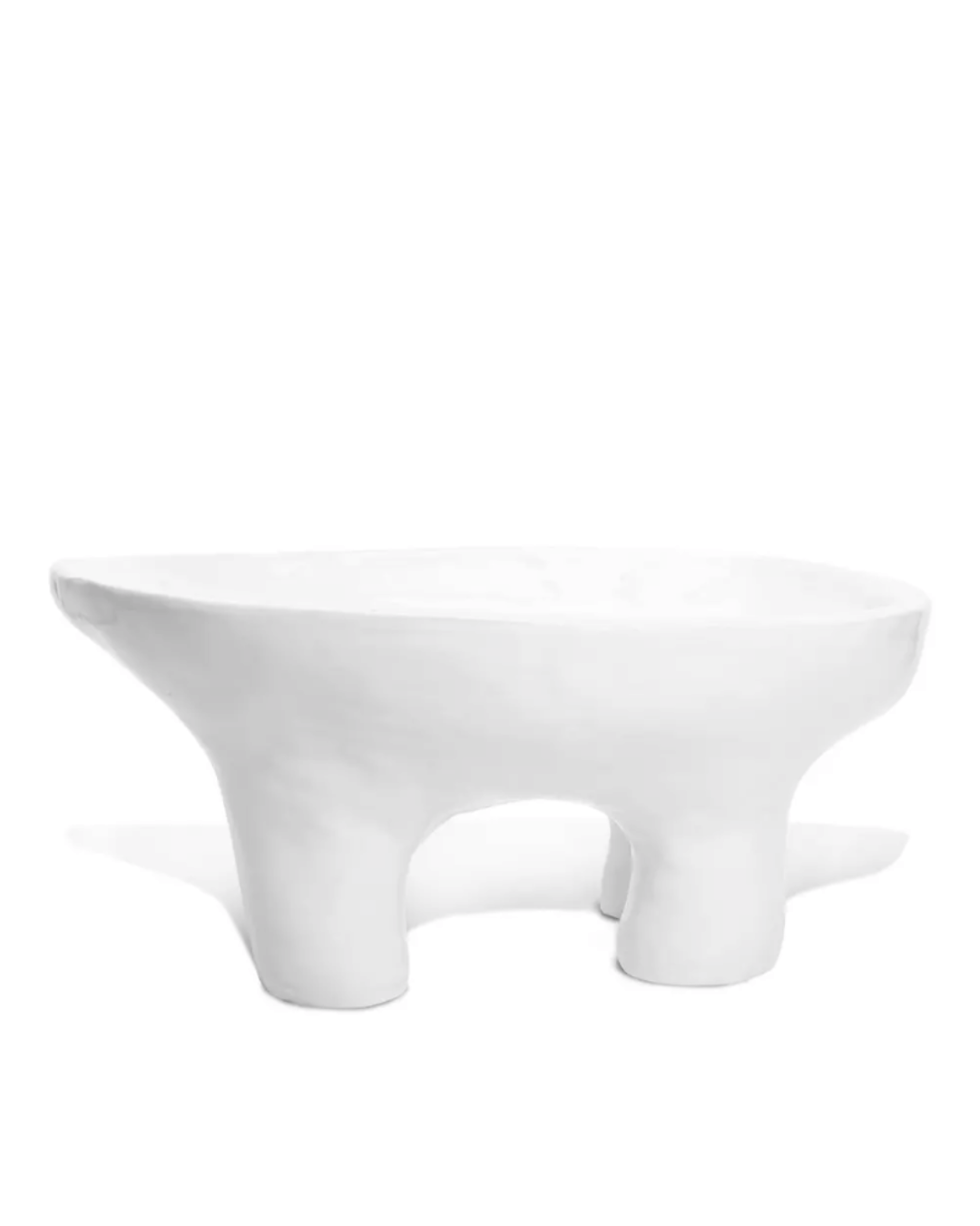 The 4846 Bowl No.846 by Montes Doggett is a modern, minimalist white ceramic bowl featuring three short, rounded legs that support a shallow basin. Crafted by Peruvian artisans, this bowl boasts an irregular, organic shape with smooth, clean lines and a matte finish.