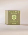 Herbituals olive green candle box with botanical pattern and yellow text, herbal scent by Faire.