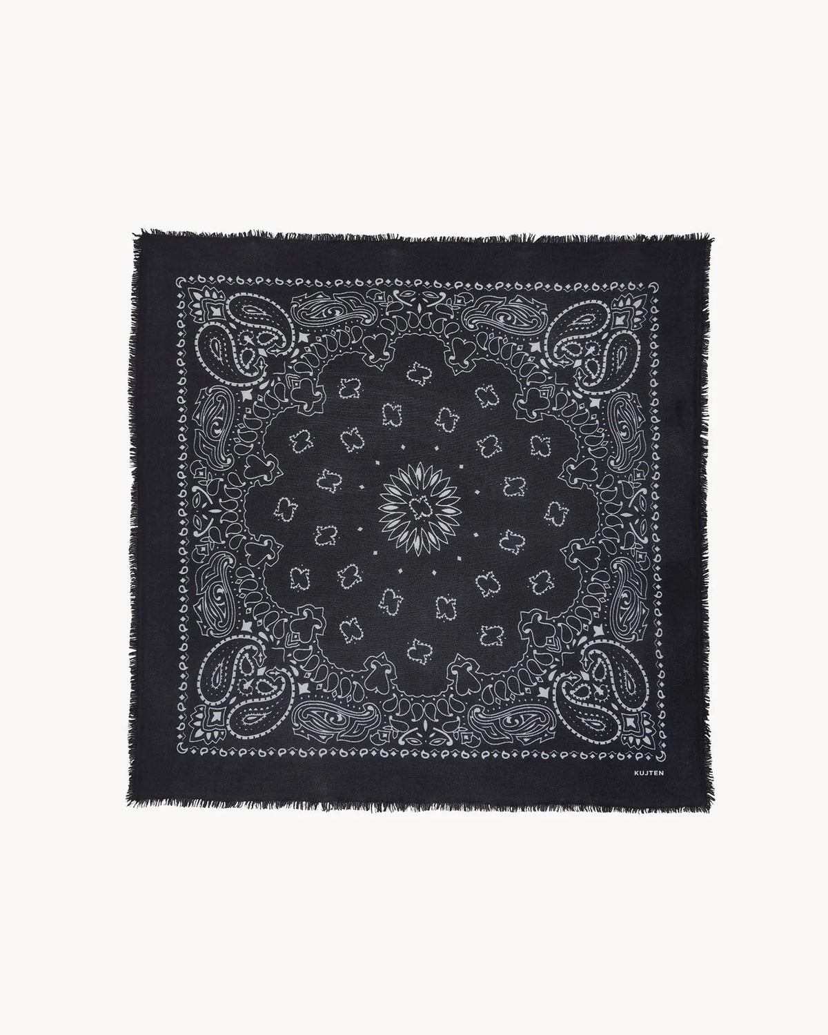 Black cashmere scarf with white paisley print and frayed edges by KUJTEN, shown flat on a white background.