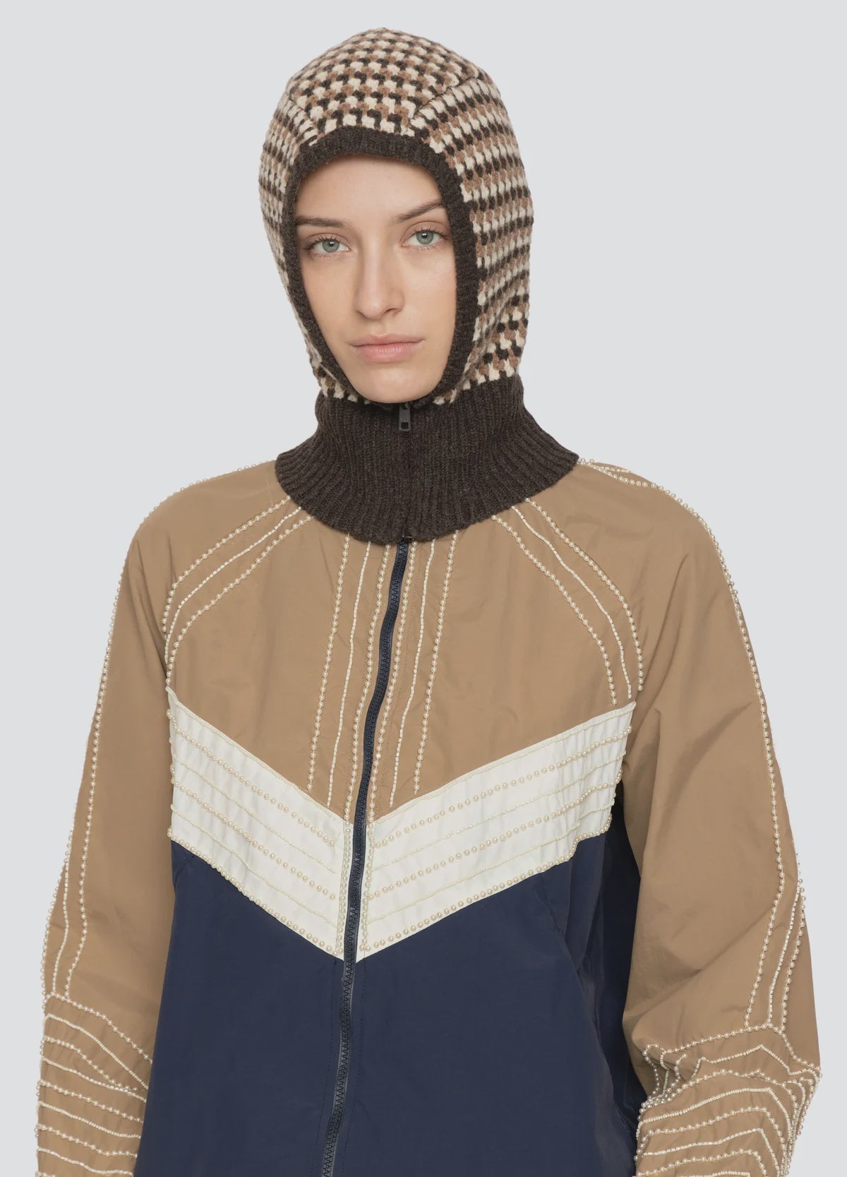 Tan and navy zip-up jacket with white stitching, styled with a DECLAN BALACLAVA by Sea New York.