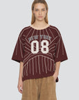 Maroon varsity-style Quinn Emb Beaded T-shirt featuring pearl-beaded pinstripes and New York 08 text.