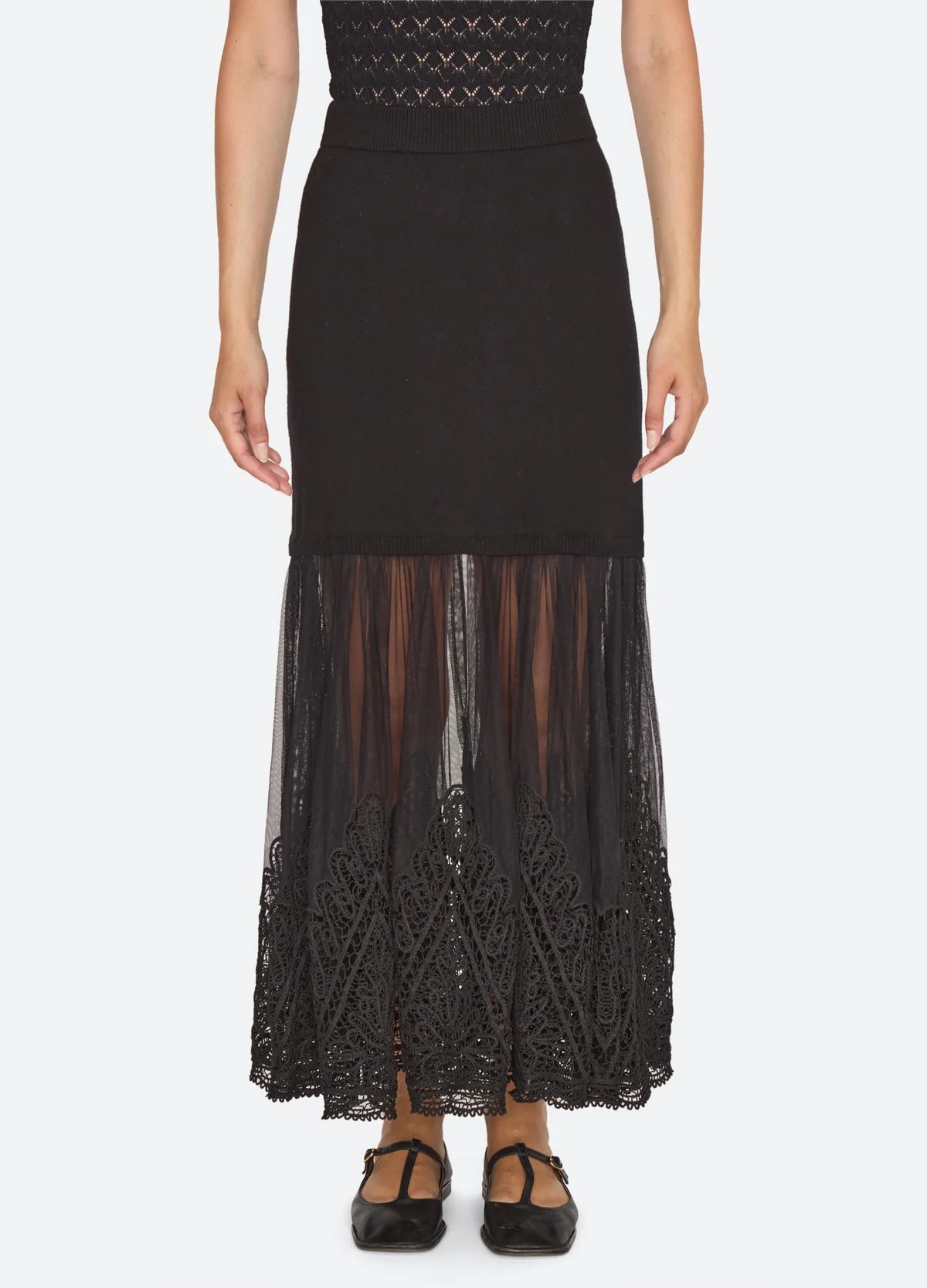 Black ribbed knit maxi skirt by Sea New York featuring a sheer pleated tulle hem and ornate lace trim.