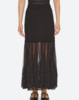 Black ribbed knit maxi skirt by Sea New York featuring a sheer pleated tulle hem and ornate lace trim.