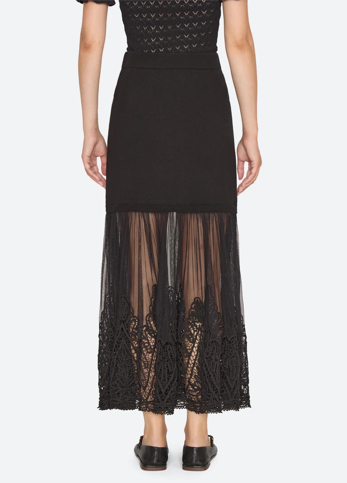 Black ribbed knit maxi skirt by Sea New York featuring a sheer tulle hem with intricate lace embroidery.