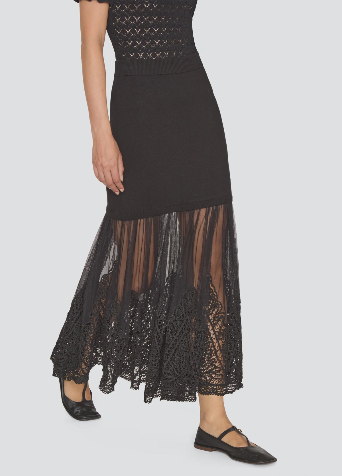 Black ribbed knit Sea New York Vali maxi skirt featuring a sheer tulle hem with intricate lace embroidery.