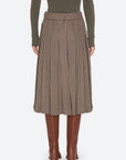 Julia Plaid Midi Skirt in a pleated style, viewed from the back with brown leather boots.
