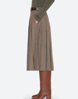 Julia Plaid Midi Skirt in a pleated side view, styled with a sweater and brown leather boots.