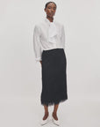 Rag & Bone Amalia black fringe column skirt and white tie-neck blouse.