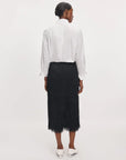 Amalia fringe midi skirt in black styled with a white button-down shirt and heels.