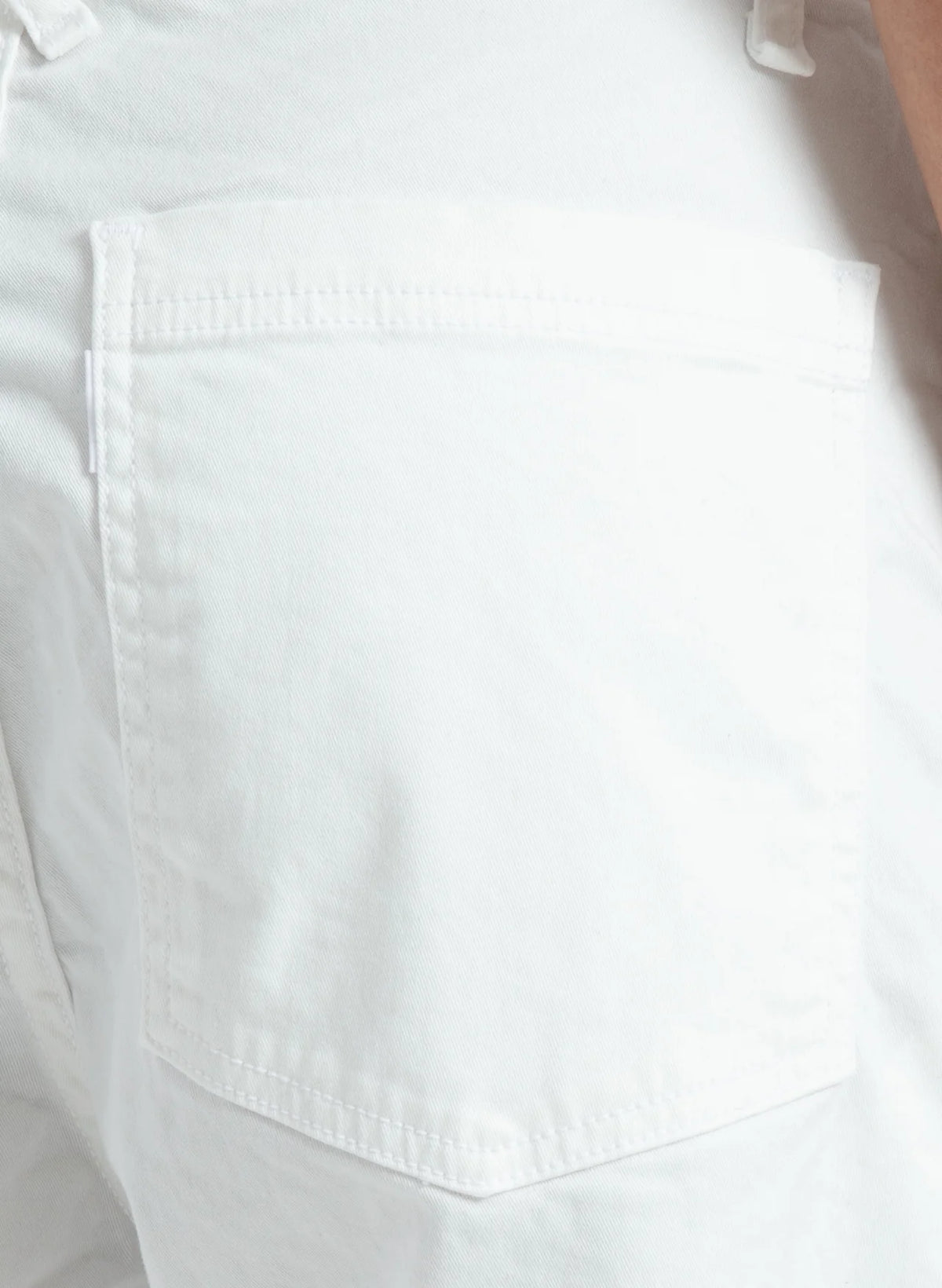 Close-up of the back pocket on ASKK chino twill white relaxed pants, highlighting the stitching and fabric texture.