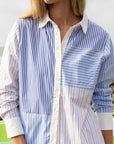 Woman wearing THE SHIRT’s Boyfriend Shirt in patchwork blue and white stripes, modern fit with No Gape detail.