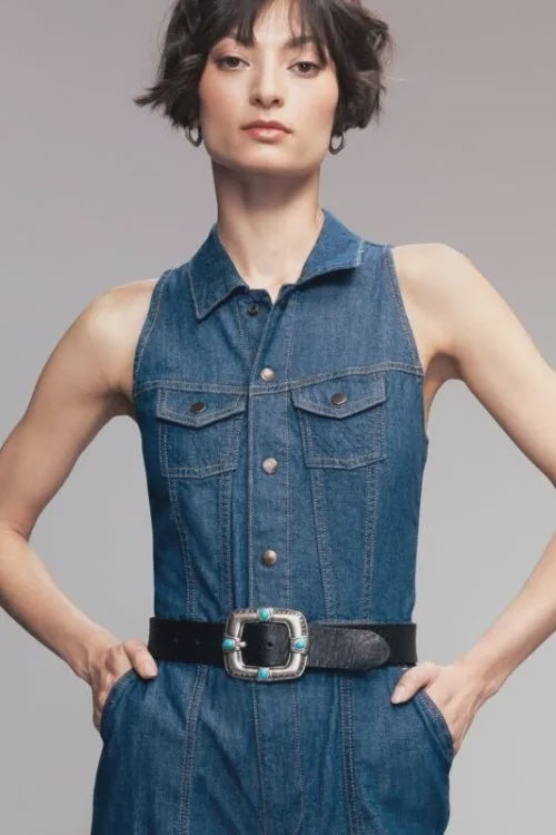 B.Belt Pansy 20mm leather belt in brown on a sleeveless denim jumpsuit, hands in pockets, casual style.