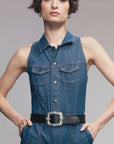 B.Belt Pansy 20mm leather belt in brown on a sleeveless denim jumpsuit, hands in pockets, casual style.