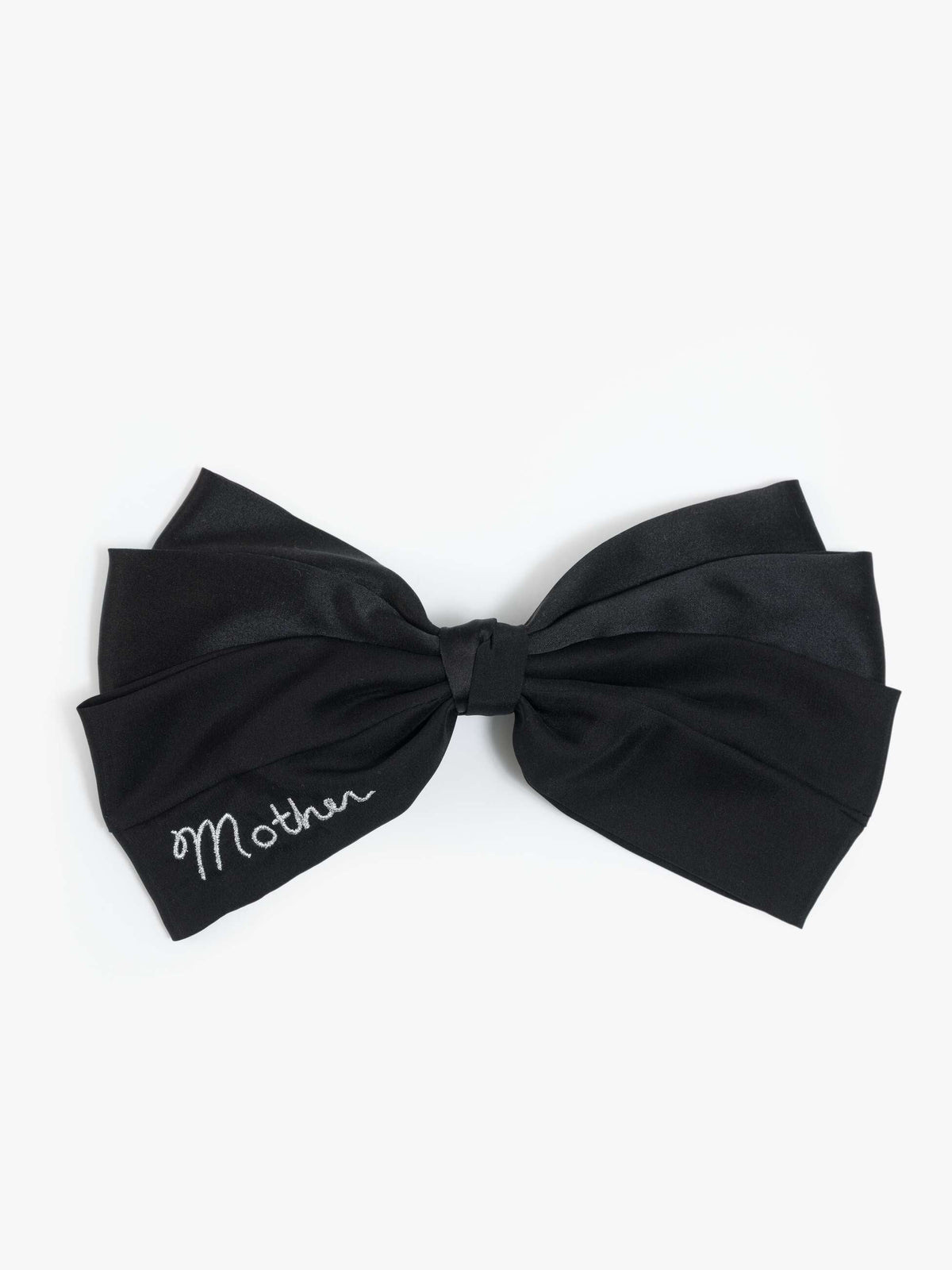 Mother THE BOW hair accessory in black silk with white embroidered script and a secure barrette.