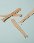 Four whale-shaped spreaders from Be Home displayed on a light blue background.