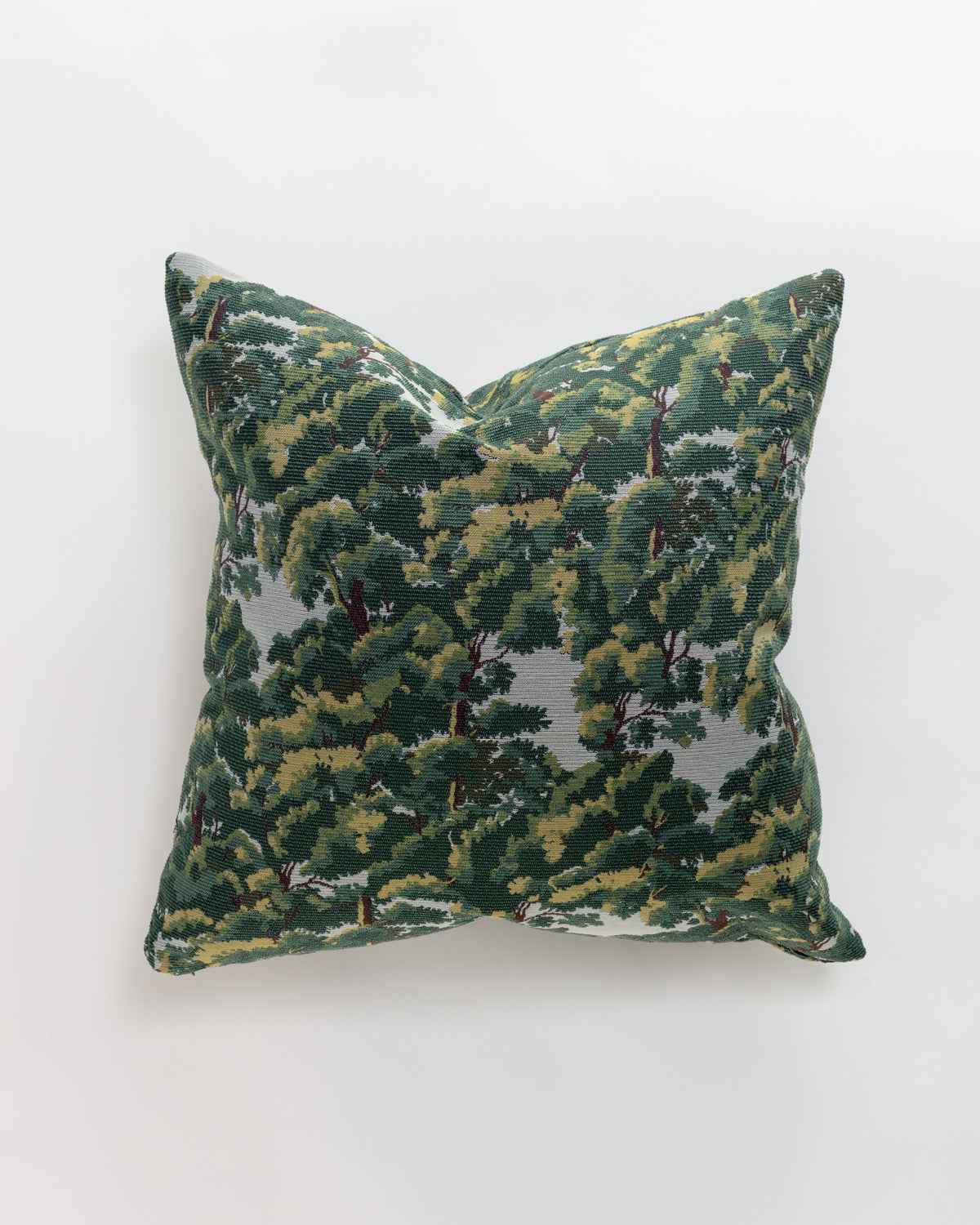 The North Oaks Pillow by Norwalk features a detailed green and yellow leafy tree pattern on a light fabric cover—an elegant touch to enhance your pillow collection.