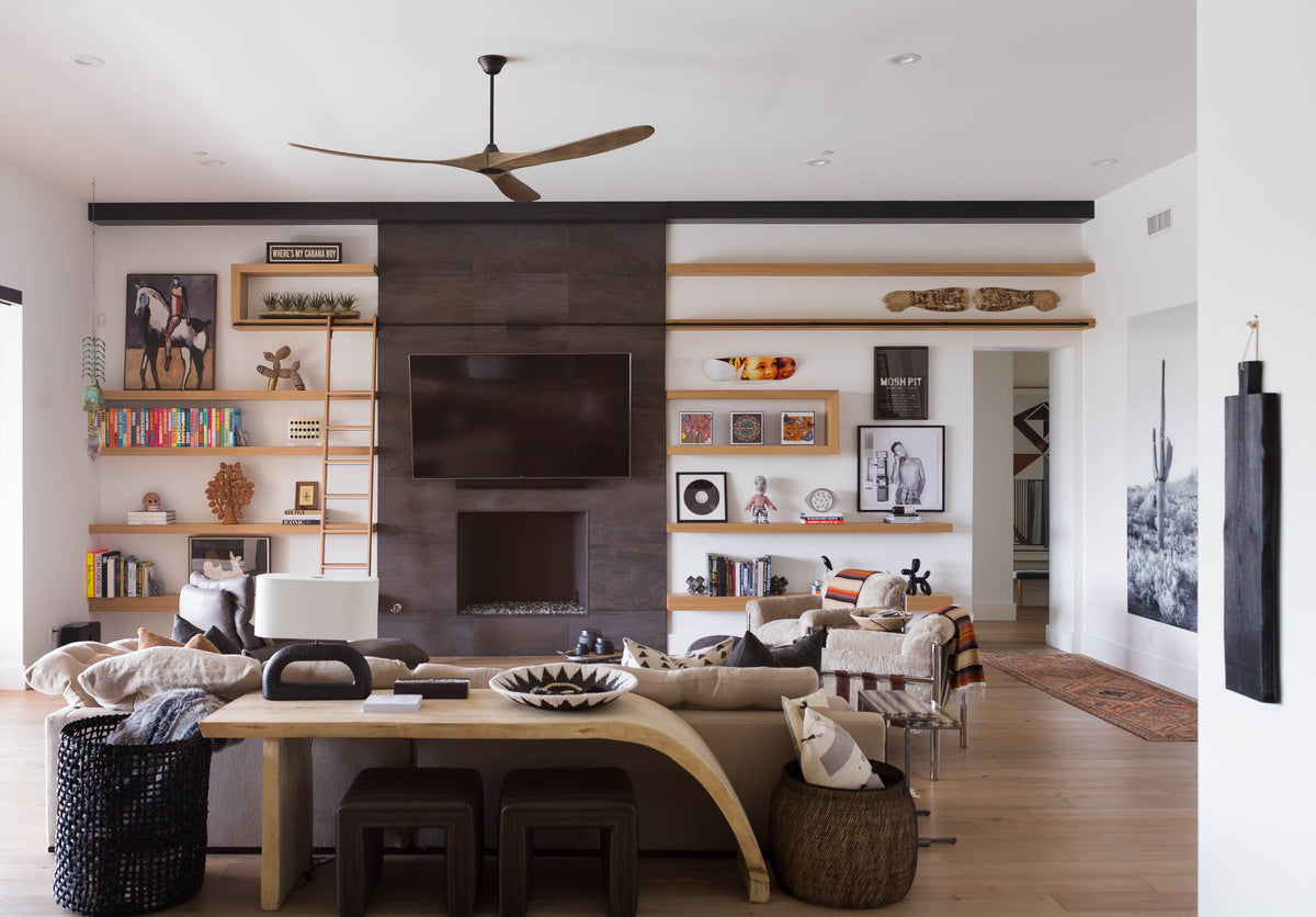 Neutral-toned modern sofa in a stylish living room by Bungalow Furniture, accented by fireplace and artwork.
