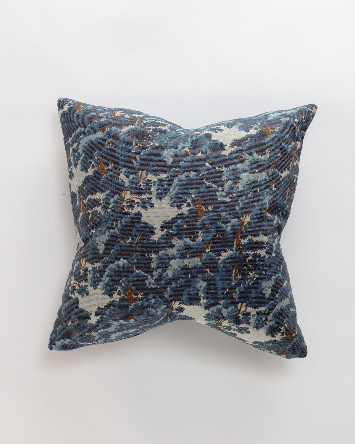 The North Oaks Pillow by Norwalk features a dark blue and white leafy pattern, adding luxurious elegance to any space. Shown against a plain white background.