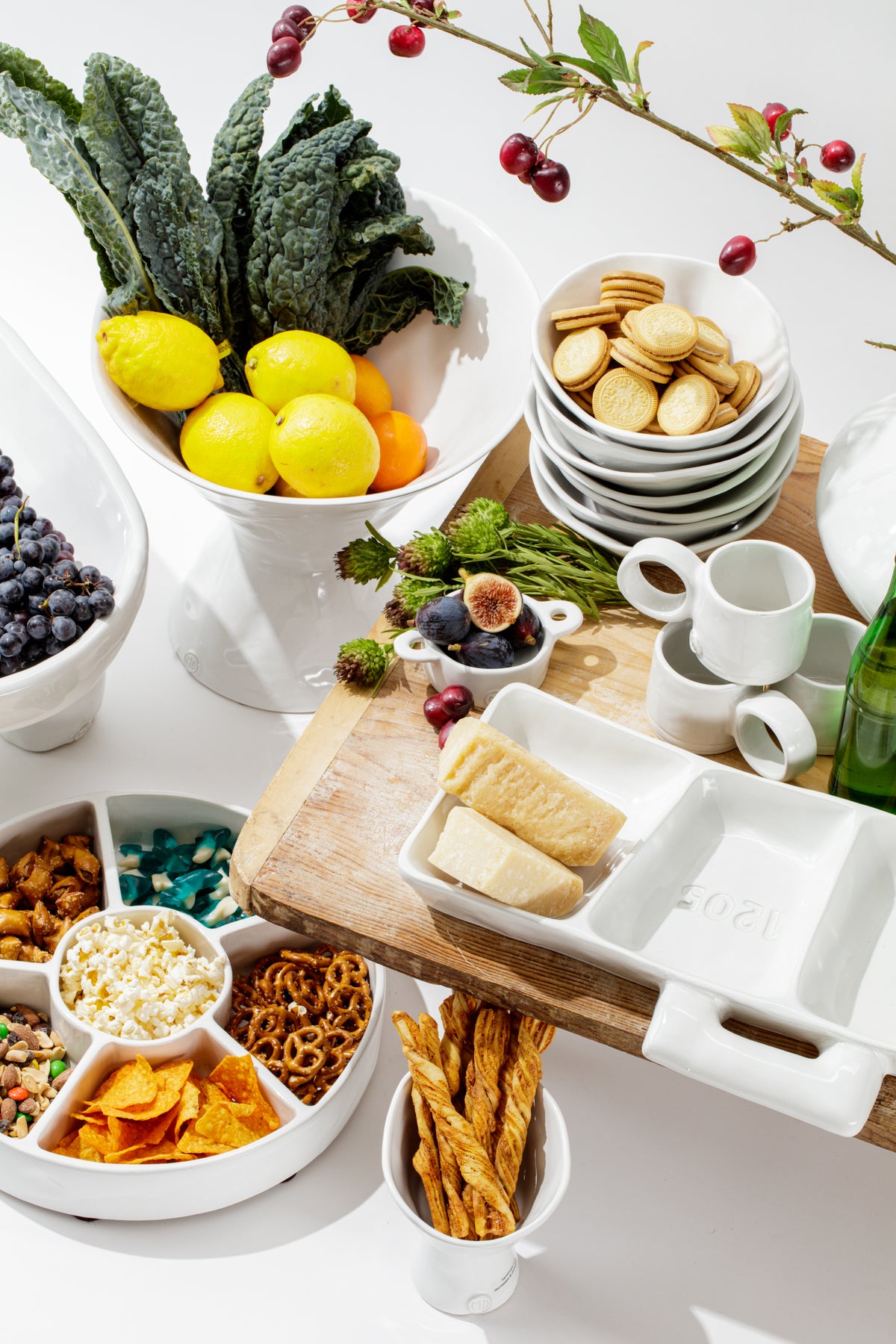 Colorful snack assortment on white dishes, styled for a fresh, inviting gathering by Bungalow Furniture & Accessories.