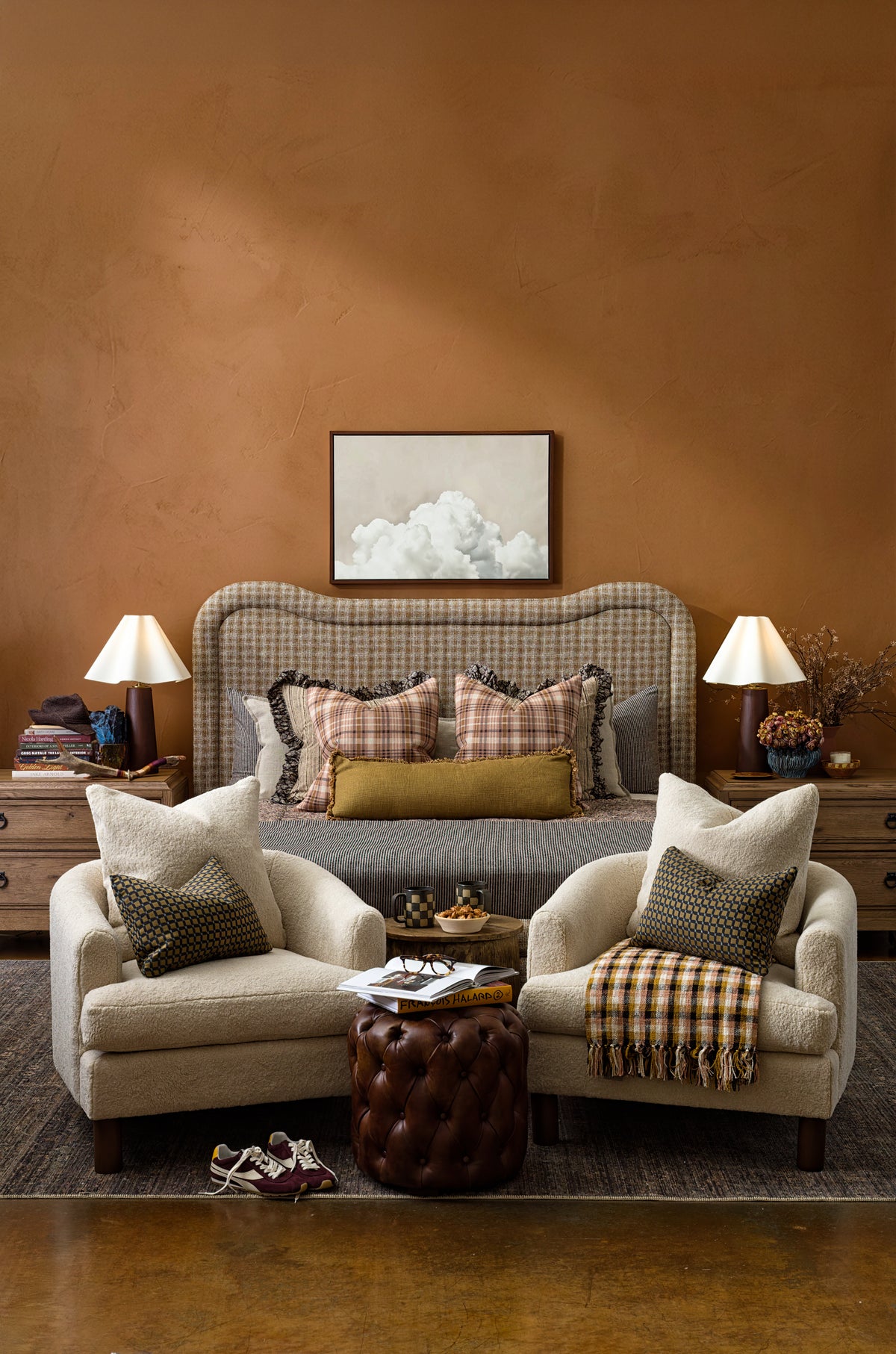 Inviting bedroom featuring Bungalow Furniture’s cozy armchairs and bed with plaid accents in a warm, relaxed setting.