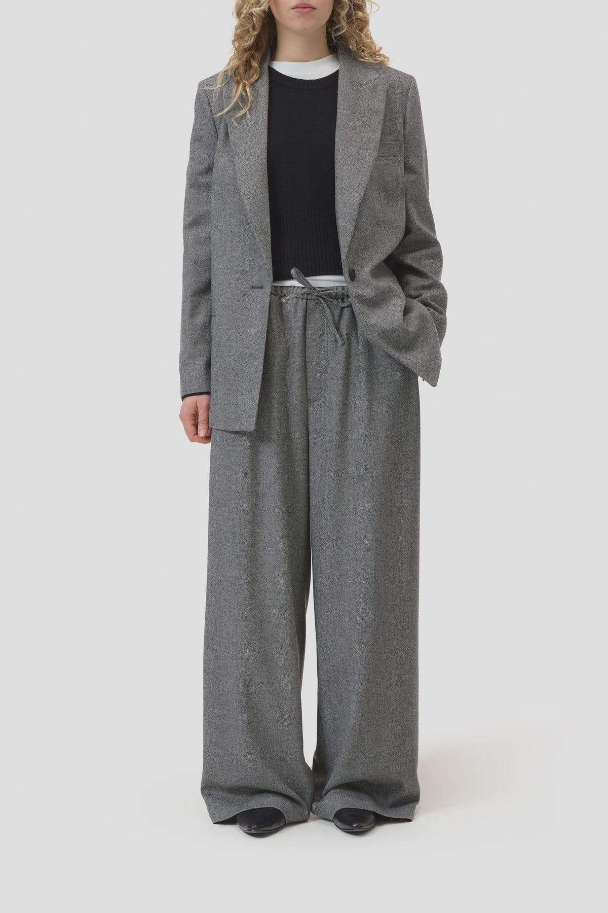 CLOSED Wynston grey flannel twill wide-leg trousers styled with black shoes and layered tops in a modern setting.