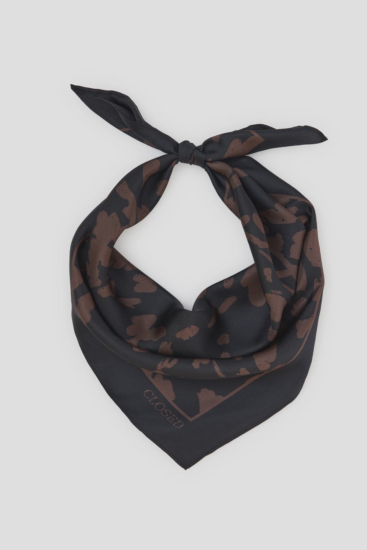 Black silk square scarf with brown animal print, logo in corner, CLOSED accessory on white background.