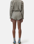CLOSED Boxer Pantie styled with a relaxed plaid shirt, gray socks, and blue-heeled sandals in a casual setting.