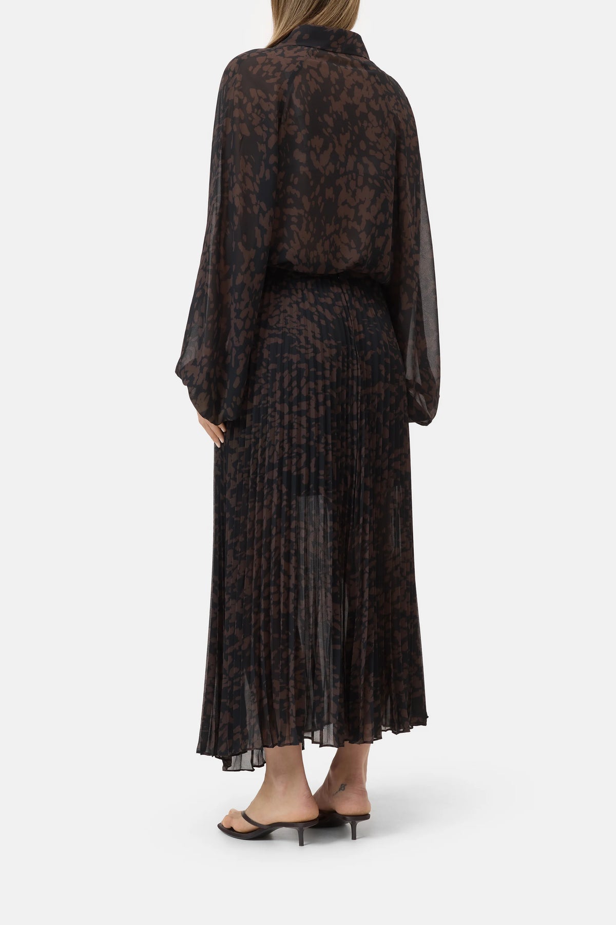 Pleated skirt in a back view paired with black heeled sandals, CLOSED brand, white background.