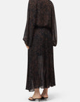 Pleated skirt in a back view paired with black heeled sandals, CLOSED brand, white background.