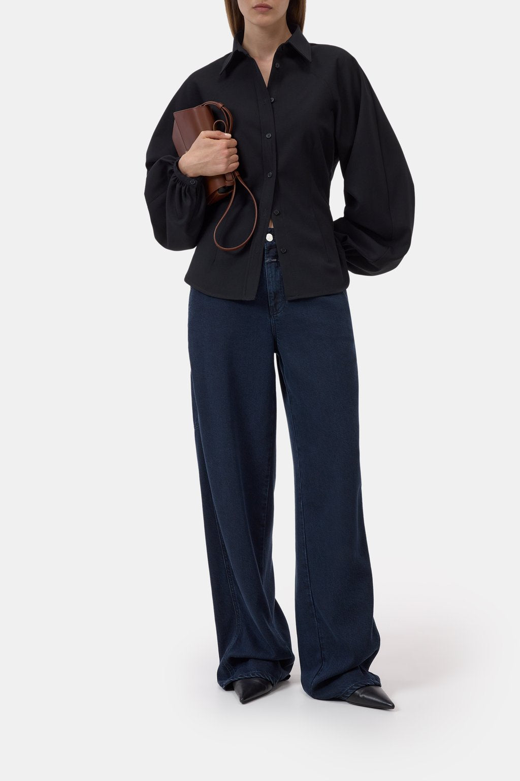 CLOSED Raglan Shirt and wide-leg blue jeans styled with black shoes and a brown clutch.