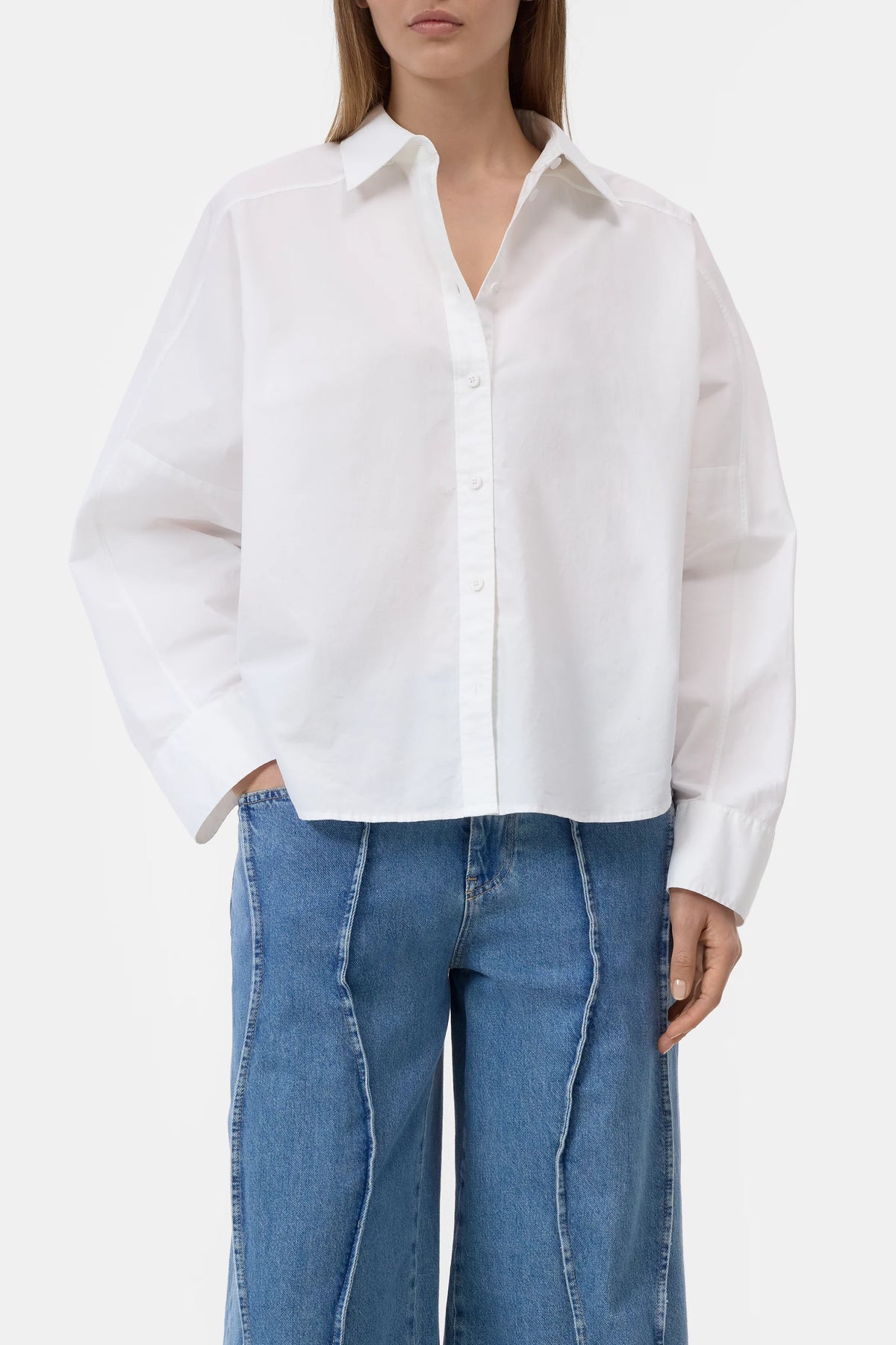 CLOSED embroidered shirt with high-waisted jeans, neutral background, modern style for Bungalow Furniture & Accessories.