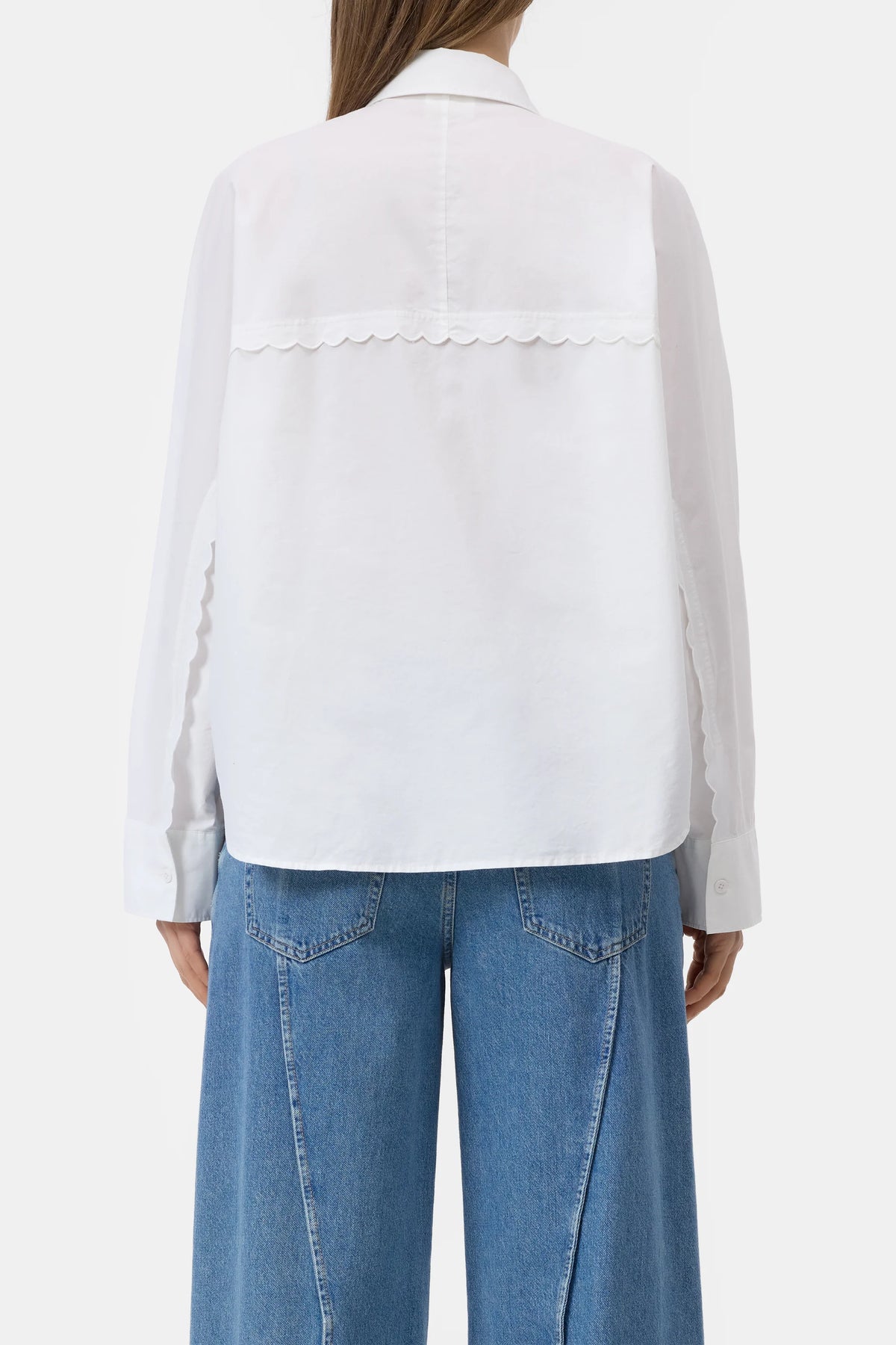 CLOSED embroidered shirt in white with blue wide-leg jeans, back view, modern casual style.