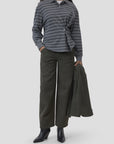 CLOSED olive polo longsleeve with matching jacket, wide-leg pants, and black boots for a modern casual look.