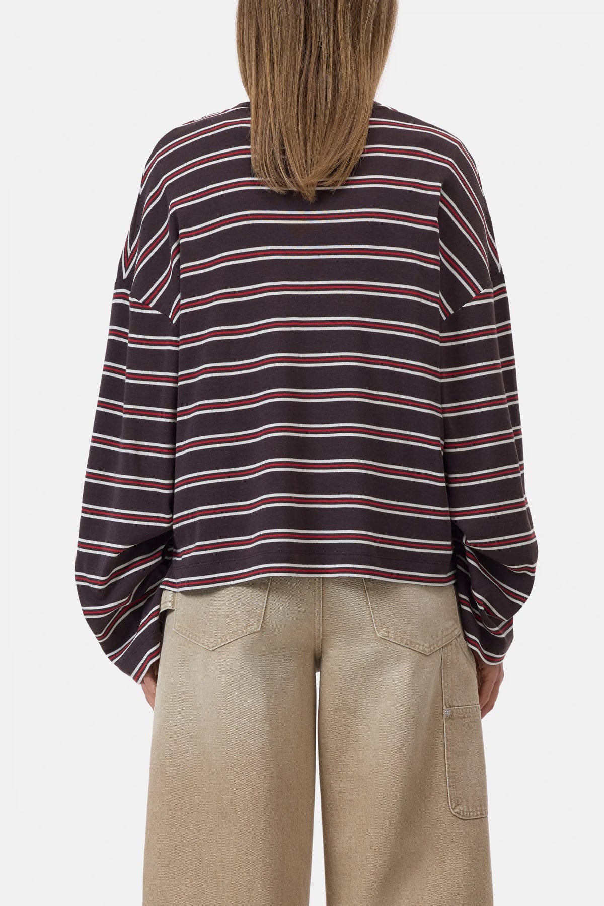 Multicoloured striped CLOSED crewneck top and beige wide-leg pants, shown from the back in a casual setting.