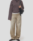 CLOSED crewneck longsleeve and baggy beige jeans styled with black shoes and a black shoulder bag.