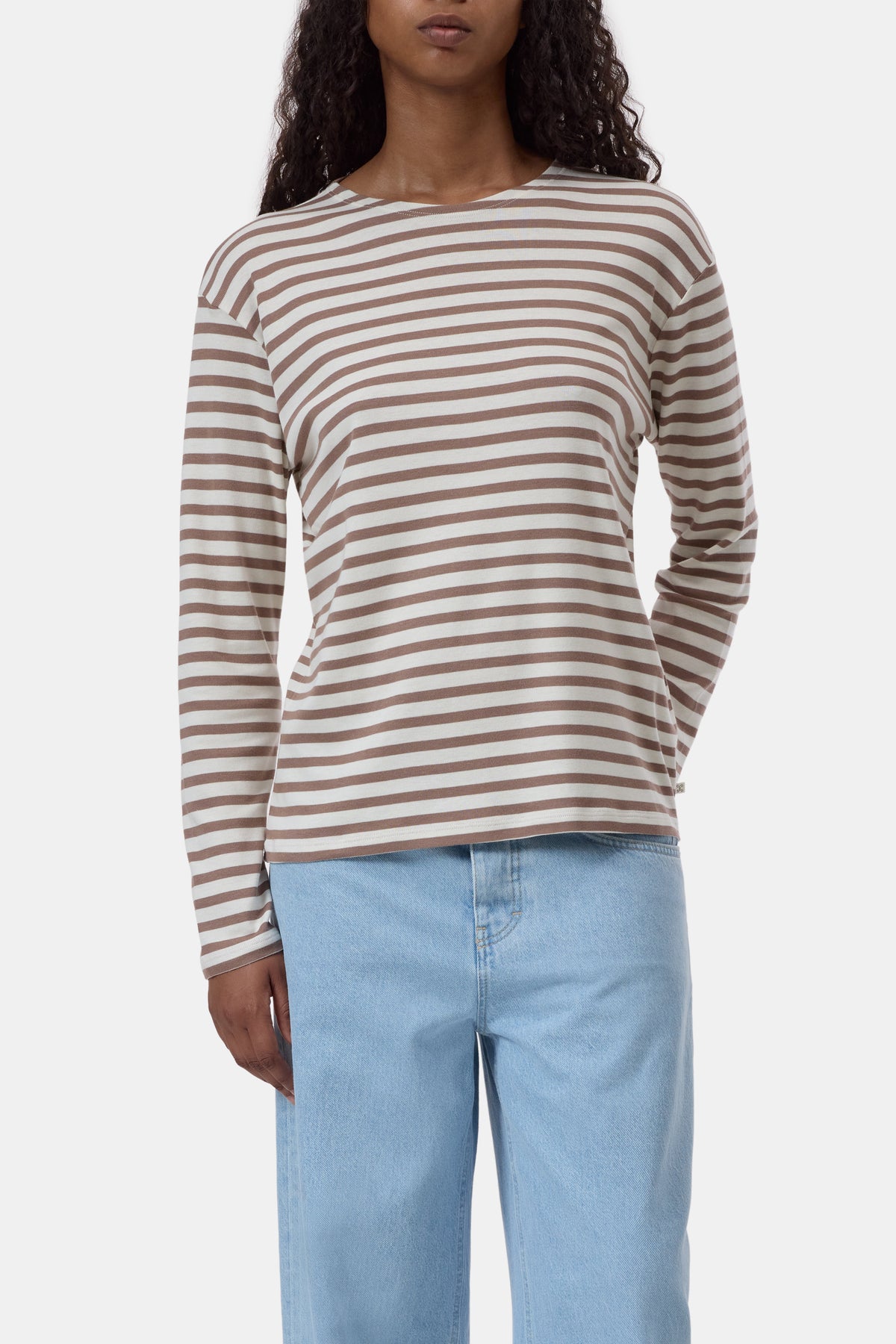 CLOSED brown and white striped long sleeve tee with light blue jeans, casual modern look.