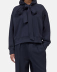 Navy CLOSED Bow Tie Hoodie and wide-leg pants set, featuring a relaxed fit with statement neck bow.