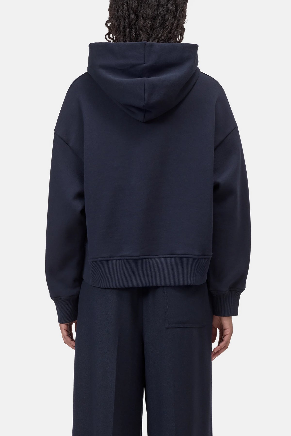 Back view of relaxed fit CLOSED Bow Tie Hoodie and pants in soft fabric, neutral color, casual loungewear set.