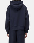 Back view of relaxed fit CLOSED Bow Tie Hoodie and pants in soft fabric, neutral color, casual loungewear set.