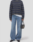 CLOSED striped crew neck sweater with wide-leg jeans and black accessories, modern casual style.
