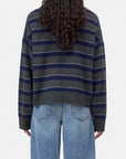 CLOSED striped crew neck sweater in blue, shown from the back with casual styling and visible curly hair.